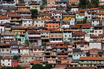 Fototapeta na wymiar The famous poor neighborhoods of the slums of Brazil and Rio de Janeiro. Favelas of the city of Ouro Preto. Panorama of poor houses in dysfunctional neighborhoods.