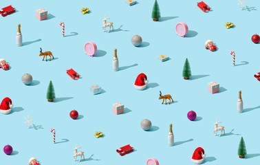 Trendy Christmas pattern made with various winter and New Year objects on bright light blue background. Minimal Christmas concept.