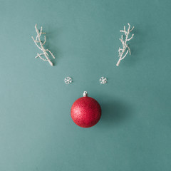 Santas reindeer made with Christmas bauble decoration and white snowy winter branches. Minimal flat...