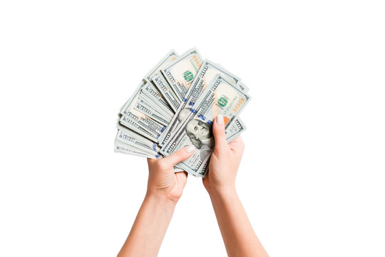 Top view of a bundle of money in female hands. Image of counting dollars on white isolated background. Tax concept