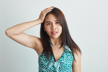 Fototapeta premium Confused, thai Asian girl clutching her head in panic isolated in white studio. OMG, what have I done, made a mistake