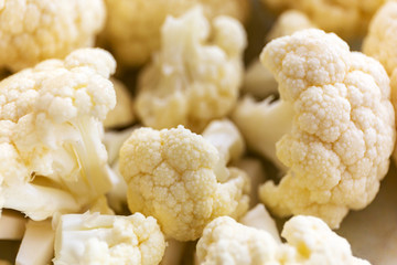 Small pieces of cauliflower on the chopping board