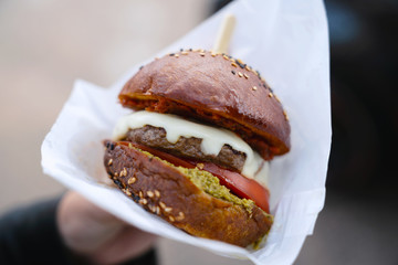 Closeup view of hamburger in a woman hands.