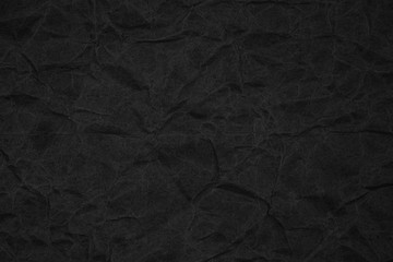 Fototapeta premium Black crumpled packaging paper background texture. Dark Kraft Paper Coarse. Wrinkled paper bag