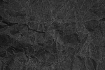 Fototapeta premium Black crumpled packaging paper background texture. Dark Kraft Paper Coarse. Wrinkled paper bag