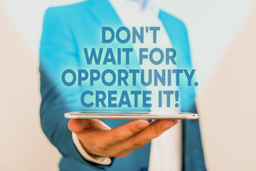 Writing note showing Don T Wait For Opportunity Create It. Business concept for work hard on yourself and begin from this moment Man in the blue suite and white shirt holds mobile phone in the hand