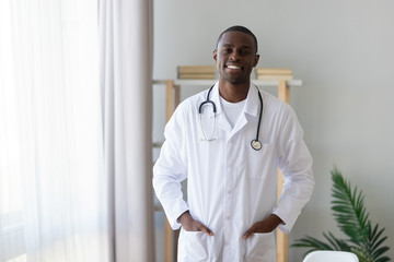 Portrait of biracial male doctor in uniform at hospital