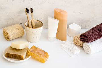 Bathroom accessories set with towels and tooth brushes on white background