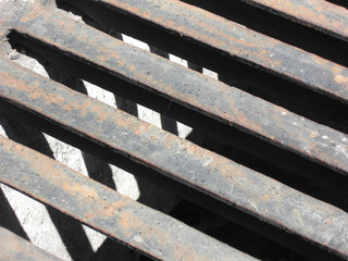 Close-up of the bars of a sewer drain, in Madrid, Spain