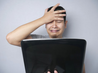 Asian Man Looked Regret and  Disappointed Expression Looking at Laptop