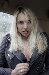 Fototapeta na wymiar Beautiful young woman with long hair in the car
