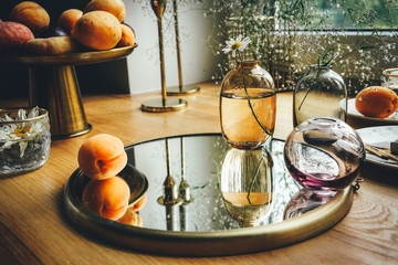 Still life with mirror, candles and apricots.