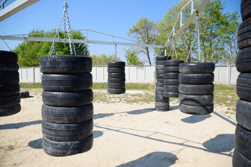 Homemade punching bags from car tires. Sports ground in the courtyard.