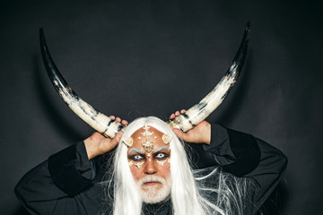 Wizard demon man with dragon skin and horns. Tree spirit and fantasy concept. Devil horns. Alien...