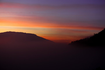 Mountains and skies before sunrise in the morning are covered by a lot of mist.