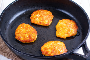 Pumpkin pancakes with honey in a pan