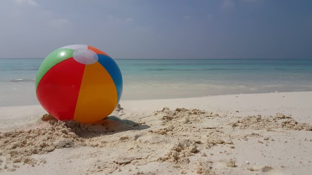 Tropical  sea ater splashing colorful beach ball 
