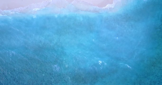 Top view of the beautiful waves hitting the beach in Maldives