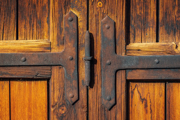 Old wooden door with crafted metal reinforcements