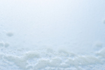 Obraz premium Abstract winter background, frozen glass covered with snow.