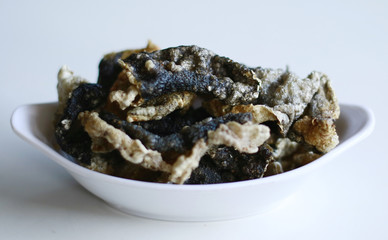 Fish skin crackers on white background. Made from patin fish. 