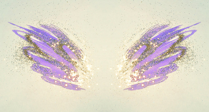 Golden glitter on abstract purple watercolor wings in vintage nostalgic colors.