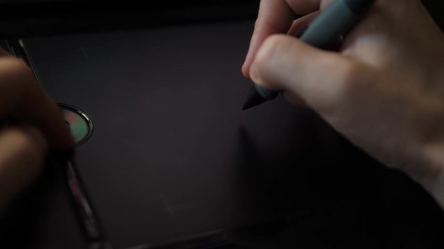 Freelance Artist working with Pen on digital graphic Tablet. POV Closeup Hand.
