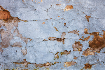 Old cracked plastered brick wall as background