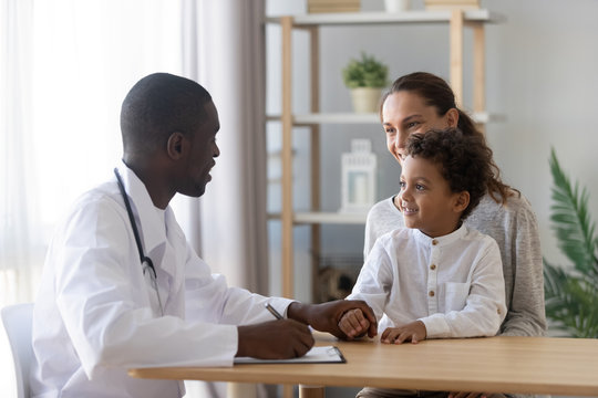 Smiling Mom With Little Son Visiting African American Doctor