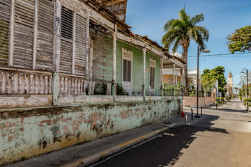 Fototapeta na wymiar Caribbean old city street, church, independence square, tropical plants , palm tree, mountain view, Puerto Plata, Dominican Republic