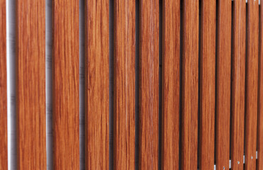 Brown wooden fence on an aluminum structure on a white background in the morning