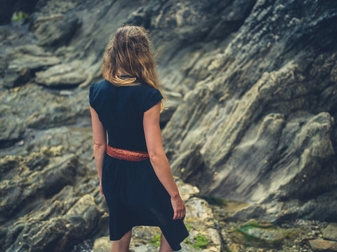 Young woman walking on rocks in the summer