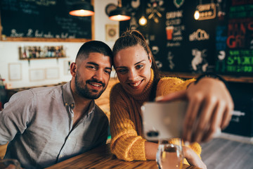 friends taking selfie picture in food corner bar