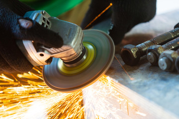 angle grinder, also known as a side grinder or disc grinder. DIY tools. Metall sparks. 