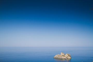Rock in the sea and blue sky