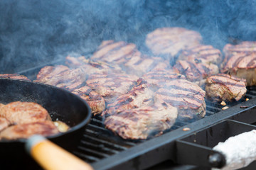 Beef steak cooking. Tasty barbecue. Rib eye steak. Raw meat. Juicy marbled meat on BBQ grill. Medium rare meat roasting