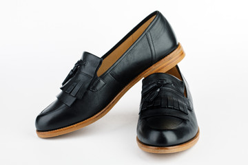 Women's black ballet flats on white background.