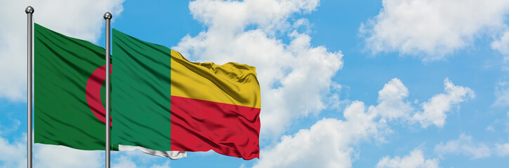 Algeria and Benin flag waving in the wind against white cloudy blue sky together. Diplomacy concept, international relations.