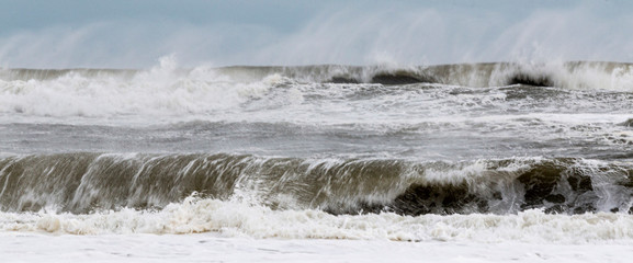 Rough ocean waves from tropical storm with heavy winds blowing the water