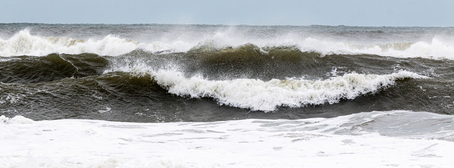 Rough ocean waves from tropical storm with heavy winds blowing the water