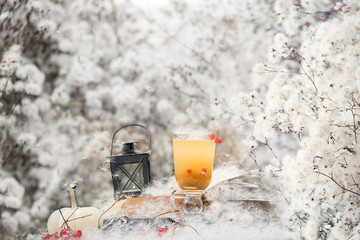 lantern with a candle and tea inside among white fluffs. fabulous magical photo.  autumn cozy still life.