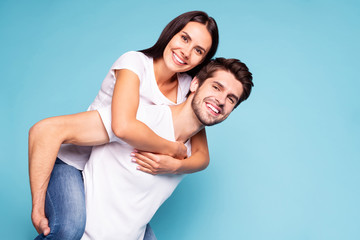 Portrait of his he her she nice attractive lovely charming cute sweet tender cheerful cheery soulmate piggybacking having fun isolated on bright vivid shine vibrant blue turquoise background