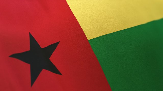 3D rendering of the national flag of Guinea-Bissau waving in the wind. The  banner/emblem is made of realistic satin texture and rendered in a daylight situation. 