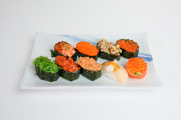 Japanese sushi of seaweed roll with Ikura, Ebiko, Hotate, Wakame, Kurage on ceramic plate