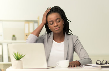 Afro Businesswoman Suffering From Headache Working In Modern Office