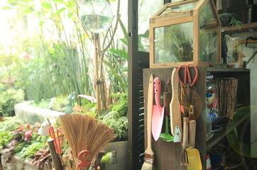 Gardening accessories hang on wooden planks in the roof garden storage.