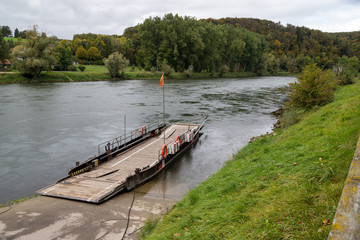 Fototapeta na wymiar Ferry at Danube river breakthrough near monastery Weltenburg in Bavaria, Germany in autumn
