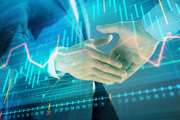 Multi exposure of forex graph on abstract background with two businessmen handshake. Concept of success on stock market