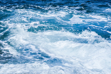 Fototapeta na wymiar Rough sea or ocean foam. Blue salt water waves background.