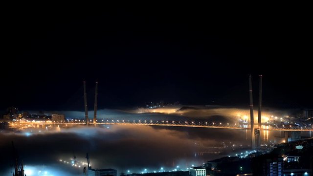 Vladivostok cityscape night view. Fog over the city. Timelapse.